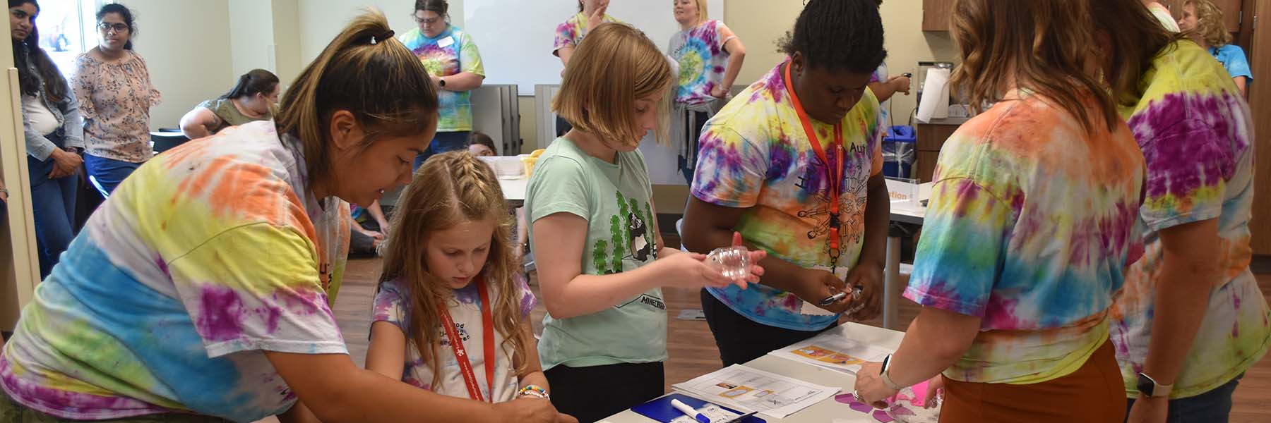 A group of staff members helping young children during an activity