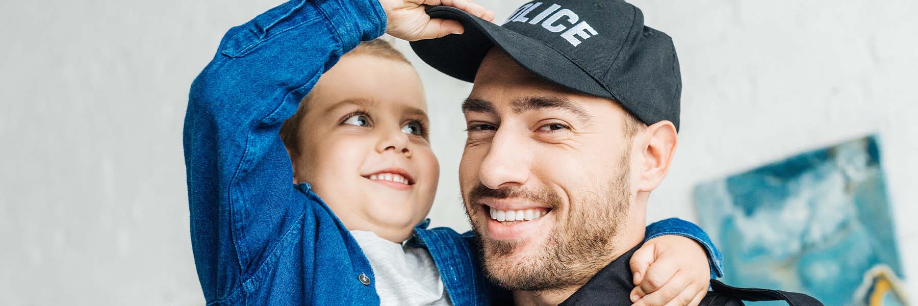 A child playing with a policeman's hat